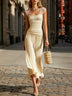 Yellow sheer-shoulder smocked top and pleated skirt set