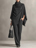 Two-piece set featuring a high-neck cape-style top and wide-leg trousers.