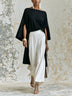 Elegant black asymmetrical top and white wide-leg pants set