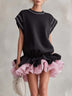 Casual black mini dress with a pink printed ruffled hem