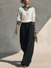 Casual two-piece set featuring a white long-sleeved top and black trousers