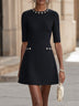 Dark blue A-line mini dress with a round neck and floral embellishment