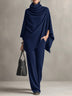 Two-piece set featuring a high-neck cape-style top and wide-leg trousers.