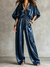 Bohemian navy pleated satin jumpsuit with a cinched waist