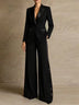 Two-piece set featuring a black satin blazer and wide-leg trousers