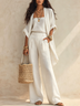 Three-piece Set Featuring A White Cardigan, Camisole, And Wide-leg Trousers